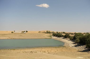 The irrigation dam of a village has lost a lot of water as a result of drought, the pond whose water has decreased, the tragic situation of the drought and irrigation pond,