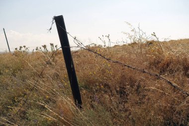 barbed wire fence damaged in the field,