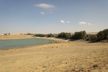 The irrigation dam of a village has lost a lot of water as a result of drought, the pond whose water has decreased, the tragic situation of the drought and irrigation pond,