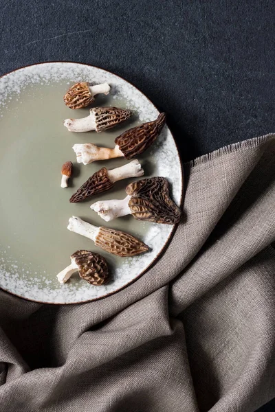 Morel Mushrooms Plate Black Background Flatlay — Stockfoto