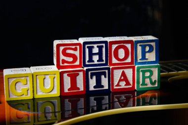 Gitar dükkanının harf küpleriyle yaptığı kelime ya da cümle bir gitarın üzerinde duruyor..