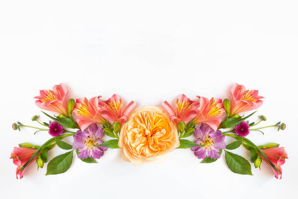 Festive floral background. floral layout from peach and orange flowers isolated. Top view, flat lay. copy space. 