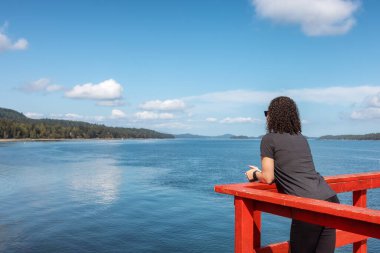 Pasifik Okyanusu 'nun batı kıyısındaki Ahşap İskeledeki Kadın