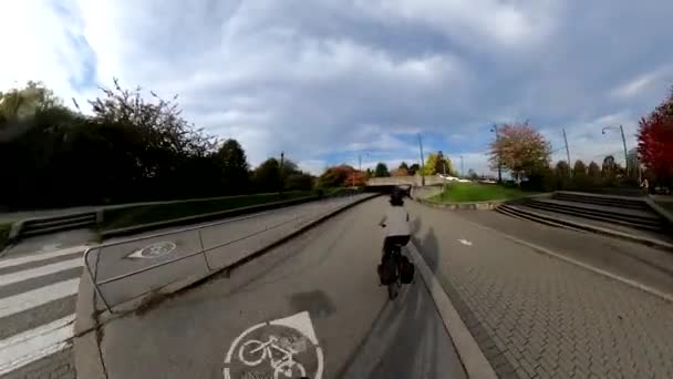 Riding a bicycle around seawall during a sunny fall season day — Stock Video