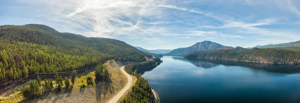 Aerial panoramic view of a scenic highway around mountains. — Stock Photo, Image