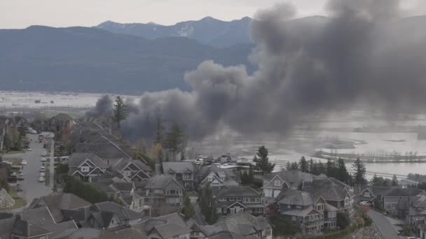 Devestating Flood and black smoke from fire in the city and farmland after storm. — Stock Video