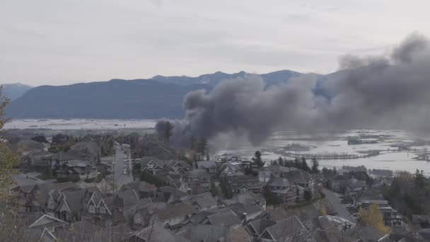 Devestating Flood and black smoke from fire in the city and farmland after storm. — Stock Video