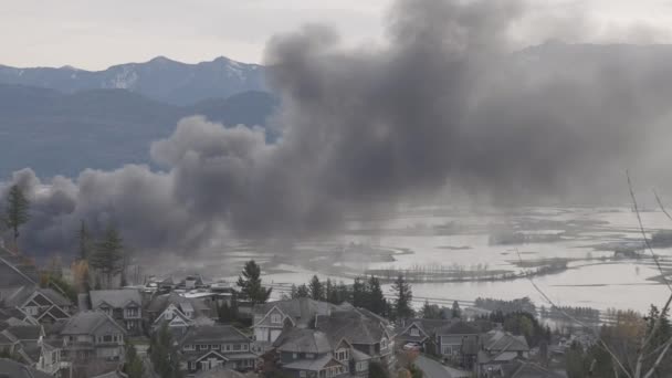 Devestating Flood and black smoke from fire in the city and farmland after storm. — Stock Video