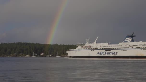 BC färjor båt lämnar terminalen i Swartz Bay med en ljus regnbåge — Stockvideo