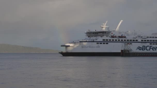 BC Ferries Boat Leaving the Terminal in Swartz Bay with a bright Rainbow — Stock Video