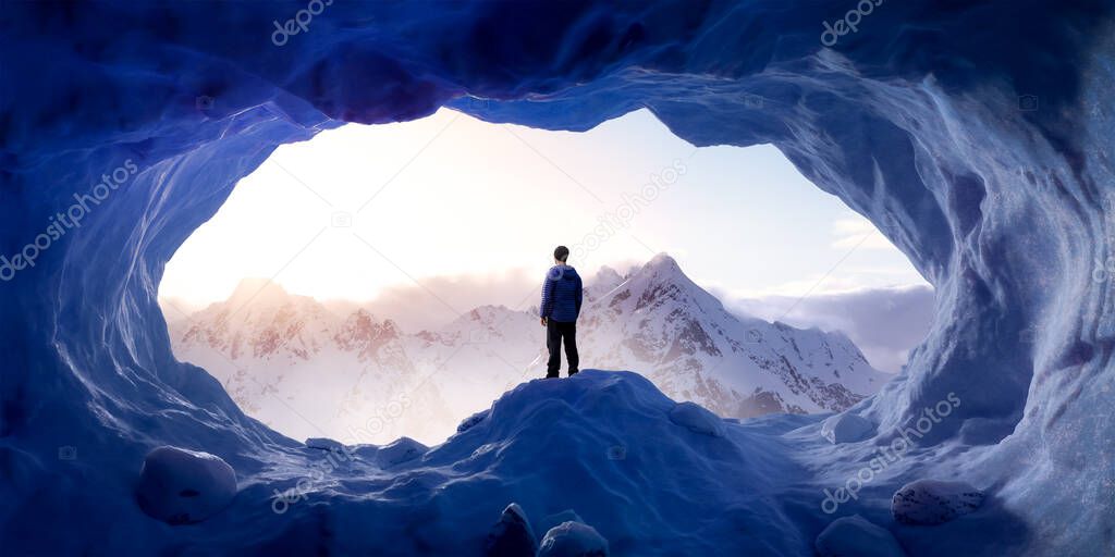 Adventurous Man Hiker standing in an ice cave with rocky mountains in background.