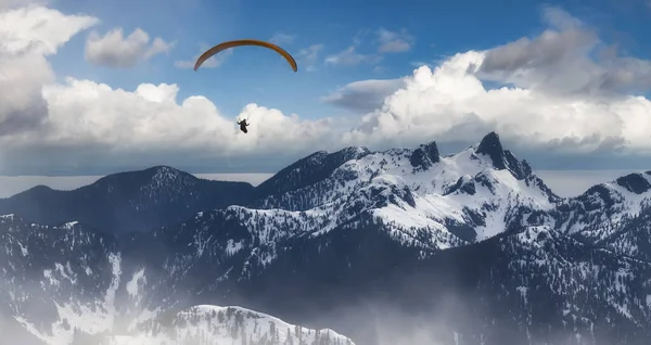 Adventure Composite Image of Paraglider Flying up high in the Rocky Mountains — Stock Photo, Image