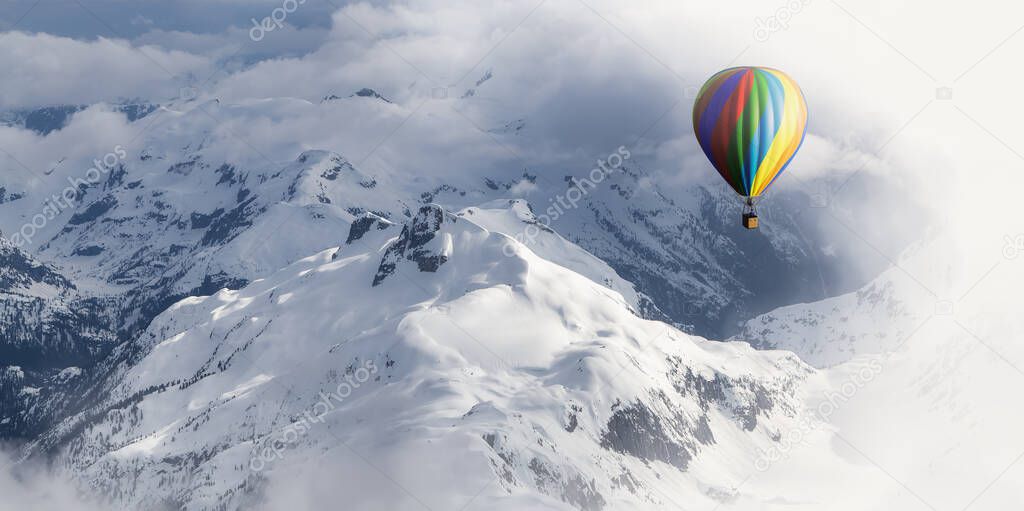 Dramatic Mountain Landscape covered in clouds and Hot Air Balloon Flying