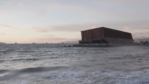 Barge container ship collided on a rocky coast during wind storm. Sunset Sky. — Stock Video