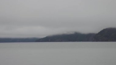 Bulutlu ve Sisli Kış Günbatımında Harrison Gölü.