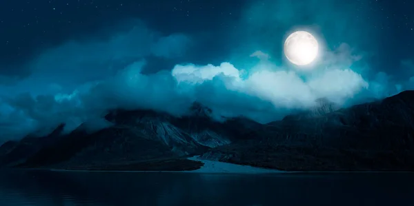 Magical Night Scene with Full Moon in cloudy sky.
