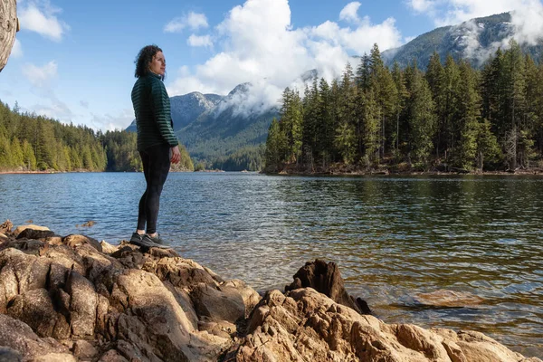 Adventurous Caucasian Woman on the rocks by the water in Canadian Nature Landscape. — Zdjęcie stockowe