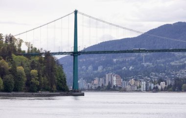 Lions Gate Bridge in a modern city on the West Coast of Pacific Ocean.