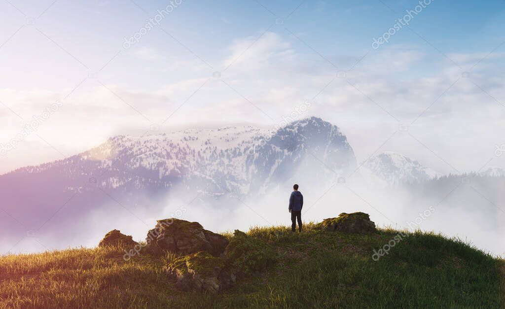 Magical fantasy scene with man on top of hill and mountain landscape in background. 3d Rendering. Dramatic Cloudy Sunset Sky. Adventure Concept