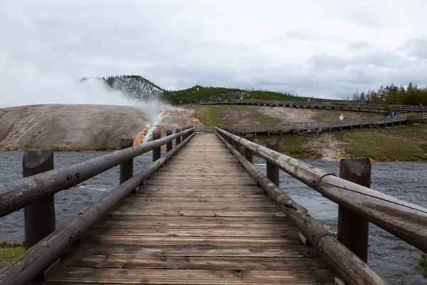 Nehrin karşısındaki köprüde, Amerikan Peyzajı 'ndaki Hot Spring Gayzer' da. Yellowstone Ulusal Parkı, Wyoming, ABD. Doğa Arkaplanı.