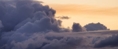 View of Cloudscape during a colorful sunset or sunrise. Taken on the West Coast of British Columbia, Canada. Nature Background clipart