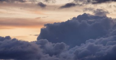 View of Cloudscape during a colorful sunset or sunrise. Taken on the West Coast of British Columbia, Canada. Nature Background
