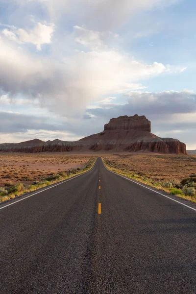 Scenic Road in the Desert with Red Rocky Mountains. Spring Season. Near Goblin Valley State Park. Utah, United States. Adventure Travel.
