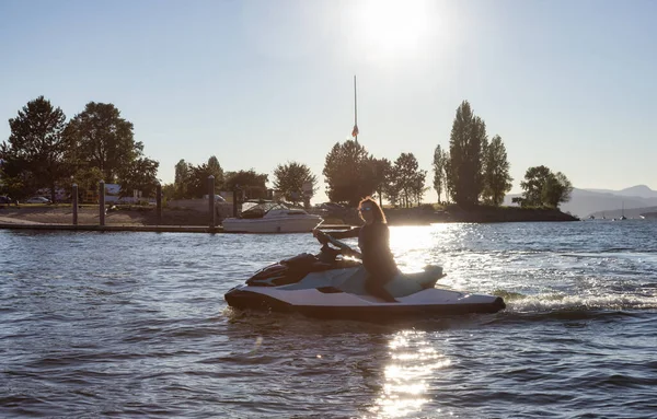 Adventurous Caucasian Woman Water Scooter Riding Ocean Sunny Sunset Sky — Stockfoto