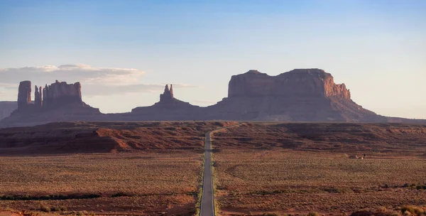Scenic Road in the Dry Desert with Red Rocky Mountains in Background. Sunset Sky. Forrest Gump Point in Oljato-Monument Valley, Utah, United States.