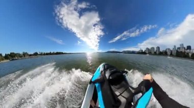 Downtown Vancouver, British Columbia, Canada - June 23, 2022: Adventurous People on Sea-Doo riding in the Ocean. Modern City in background. 360 Camera