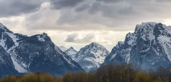 Snow Covered Mountains in American Landscape. Spring Season. Grand Teton National Park. Sunset Sky. Wyoming, United States. Nature Background.