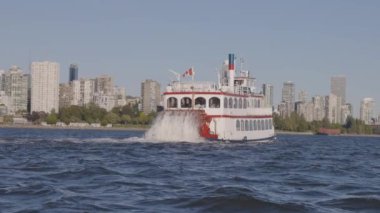 Vancouver, British Columbia, Canada - June 23, 2022: Sternwheeler passing by False Creek and cityscape in Downtown City.