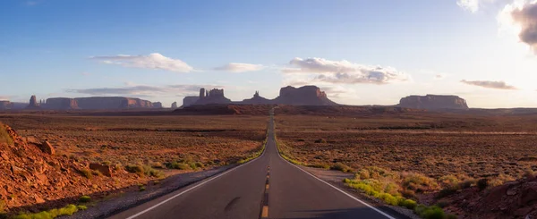 Scenic Road in the Dry Desert with Red Rocky Mountains in Background. Sunset Sky Art Render. Forrest Gump Point in Oljato-Monument Valley, Utah, United States.