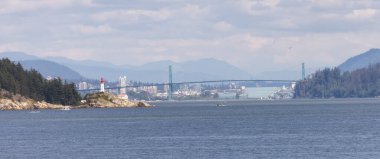 Lighthouse Park, Modern city in background during sunny summer day. West Vancouver, British Columbia, Canada.
