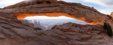 Scenic American Landscape and Red Rock Mountains in Desert Canyon. Spring Season. Sunset Sky. Mesa Arch in Canyonlands National Park. Utah, United States. Nature Background Panorama