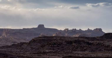 Rugged Mountain Rock Formations in the desert with dramatic clouds at sunset. Utah, United States of America. Nature Background.