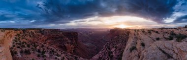 Scenic Panoramic View of American Landscape and Red Rock Mountains in Desert Canyon. Cloudy Sunset Sky. Canyonlands National Park. Utah, United States. Nature Background Panorama