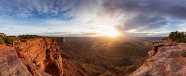 Scenic Panoramic View of American Landscape and Red Rock Mountains in Desert Canyon. Cloudy Sunrise Sky. Canyonlands National Park. Utah, United States. Nature Background Panorama