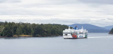 Galiano Island, British Columbia, Canada - June 21, 2022: BC Ferries Boat in Pacific Ocean during cloudy summer day.