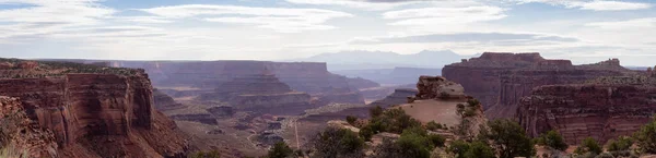 Scenic Panoramic View of American Landscape and Red Rock Mountains in Desert Canyon. Cloudy Sky. Canyonlands National Park. Utah, United States. Nature Background Panorama