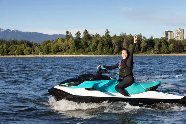 Adventurous Caucasian Woman Water Scooter Riding Ocean Modern City Background — ストック写真