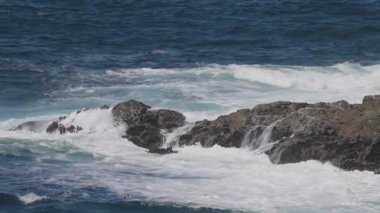 Rugged Rocks on a rocky shore on the West Coast of Pacific Ocean. Summer Morning Sky. Ucluelet, Vancouver Island, British Columbia, Canada. Nature Background. Slow Motion