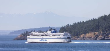 Gulf Islands, British Columbia, Canada - July 14, 2022: BC Ferries Passing By the islands on the West Coast of Pacific Ocean.