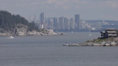 Lighthouse Park, Downtown city and Homes on the West Coast of Pacific Ocean. Sunny summer day. West Vancouver, British Columbia, Canada. Slow Motion