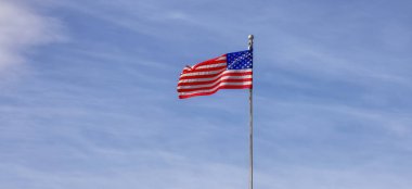 American Flag on the Cloudy background. United States of America.
