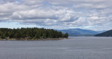 Treed Island with Homes and docks, surrounded by other islands. Summer Season. Gulf Islands near Vancouver Island, British Columbia, Canada. Canadian Landscape.