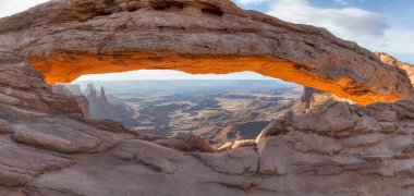 Scenic American Landscape and Red Rock Mountains in Desert Canyon. Spring Season. Sunset Sky. Mesa Arch in Canyonlands National Park. Utah, United States. Nature Background Panorama