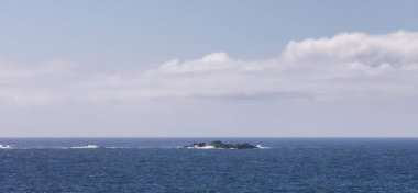 Rugged Rocks on a rocky shore on the West Coast of Pacific Ocean. Summer Morning Sky. Ucluelet, Vancouver Island, British Columbia, Canada. Nature Background