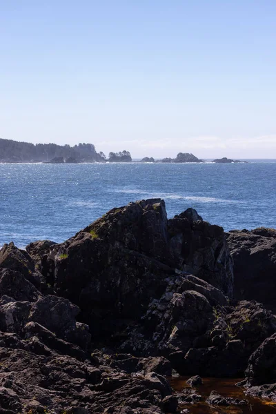 Rugged Rocks on a rocky shore on the West Coast of Pacific Ocean. Summer Morning Sky. Ucluelet, Vancouver Island, British Columbia, Canada. Nature Background