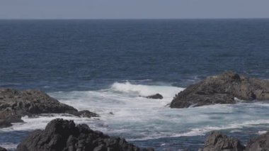 Rugged Rocks on a rocky shore on the West Coast of Pacific Ocean. Summer Morning Sky. Ucluelet, Vancouver Island, British Columbia, Canada. Nature Background. Slow Motion